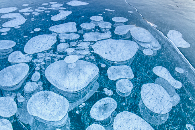 Biologically-produced methane is trapped in lake ice in Abraham Lake, Alberta.